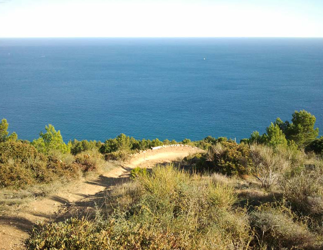 Photo of a mountain biking trail with a view of the sea in Andora